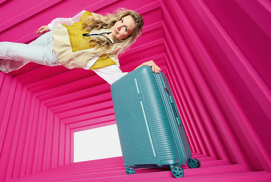 Walizka travelite w różonym kontenerze z kobietą